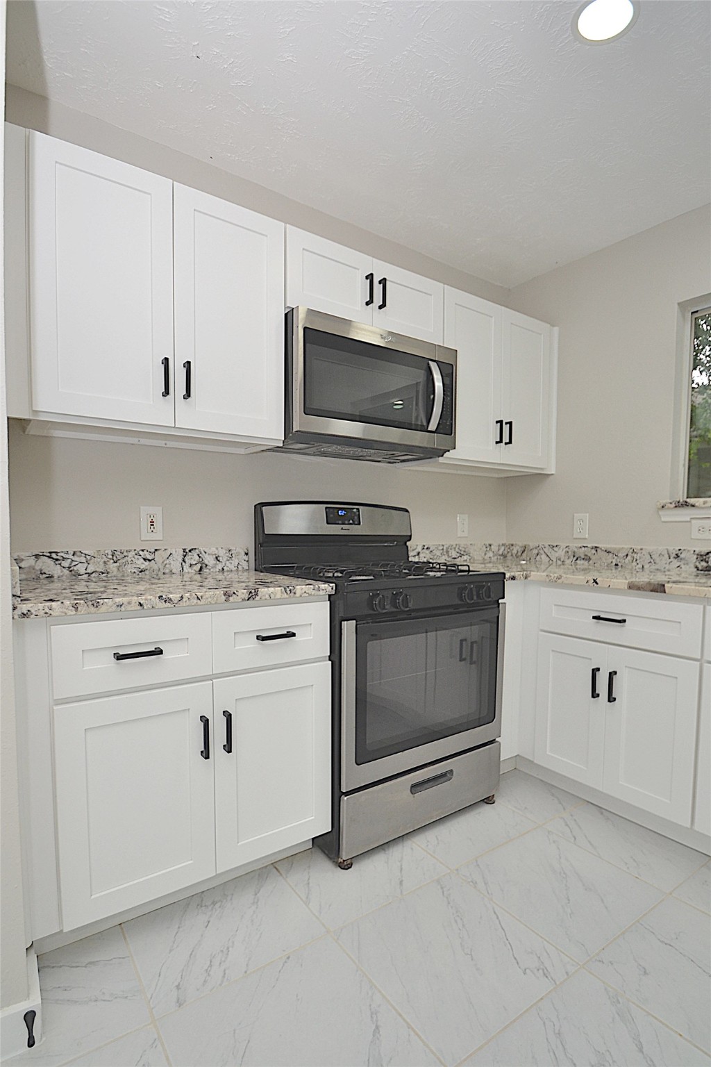 631 Aweigh Drive Crosby, TX 77532 - Photo 4 of 15 a kitchen with granite countertop white cabinets white stainless steel appliances and a sink