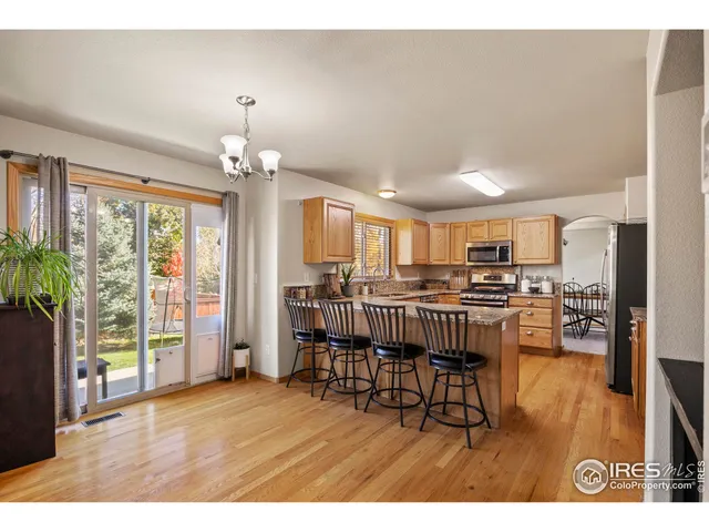 a view of a dining room with furniture and a chandelier