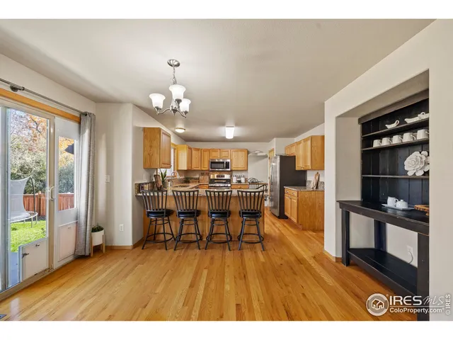 a view of a dining room with furniture and a chandelier