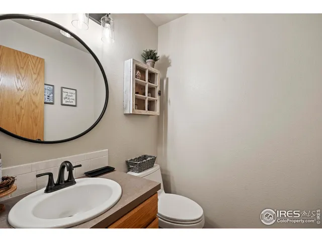 a bathroom with a sink mirror and toilet