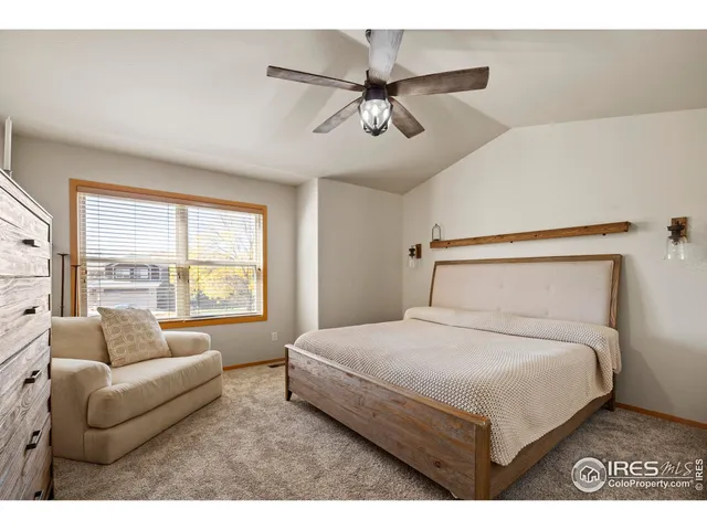 a bedroom with a bed couch and window