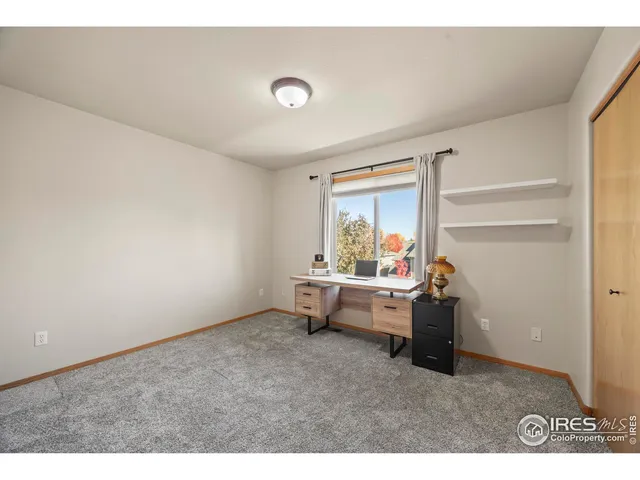a bathroom with a granite countertop sink a mirror a toilet and shower