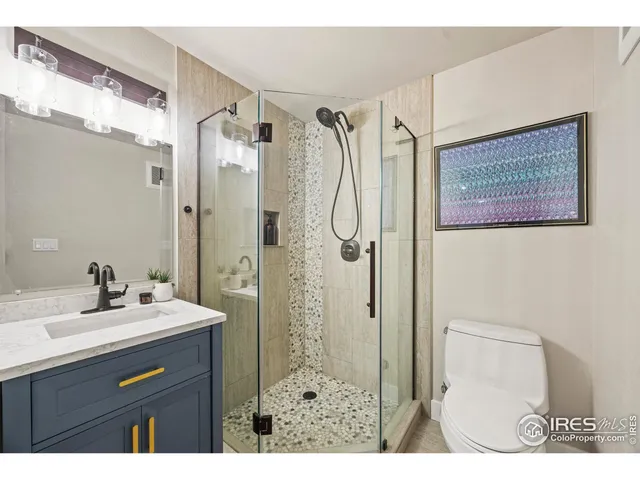 a view of a hallway with wooden floor and stairs