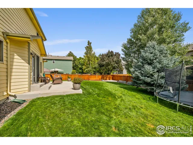 a view of backyard with wooden fence