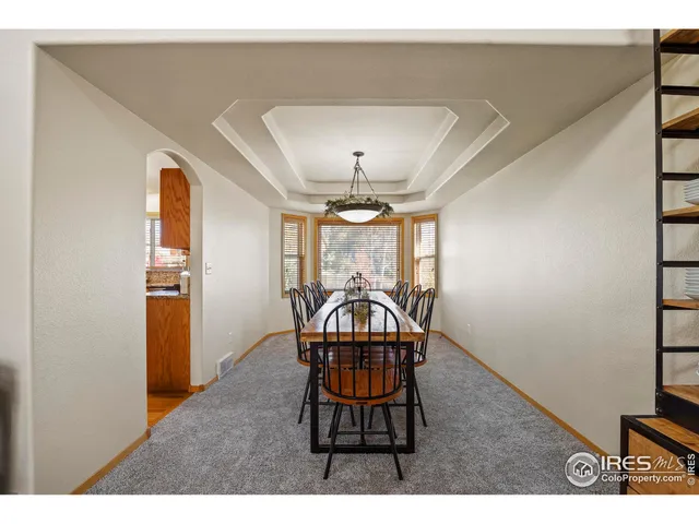 a view of a hallway with a dining area