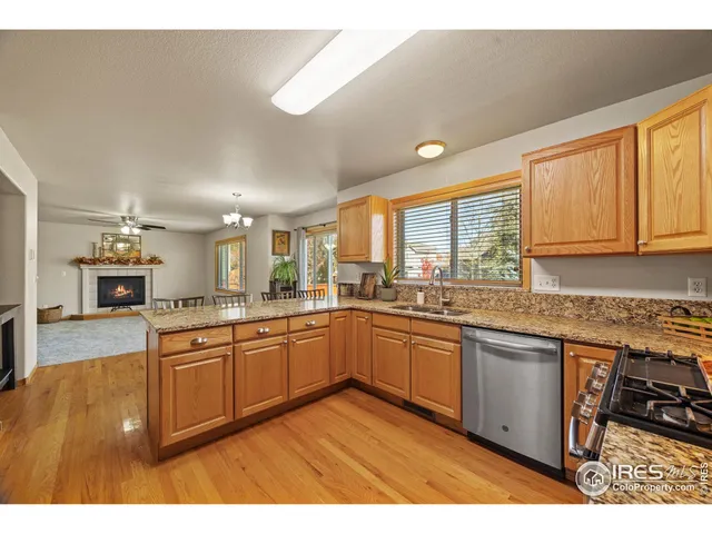 a kitchen with stainless steel appliances granite countertop a stove a sink dishwasher and a microwave