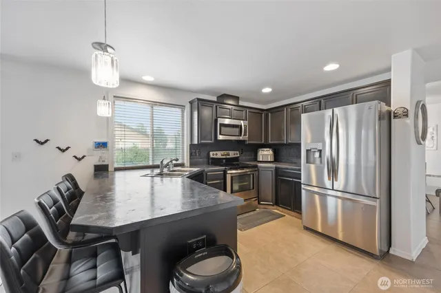 a kitchen with refrigerator cabinets dining table and chairs