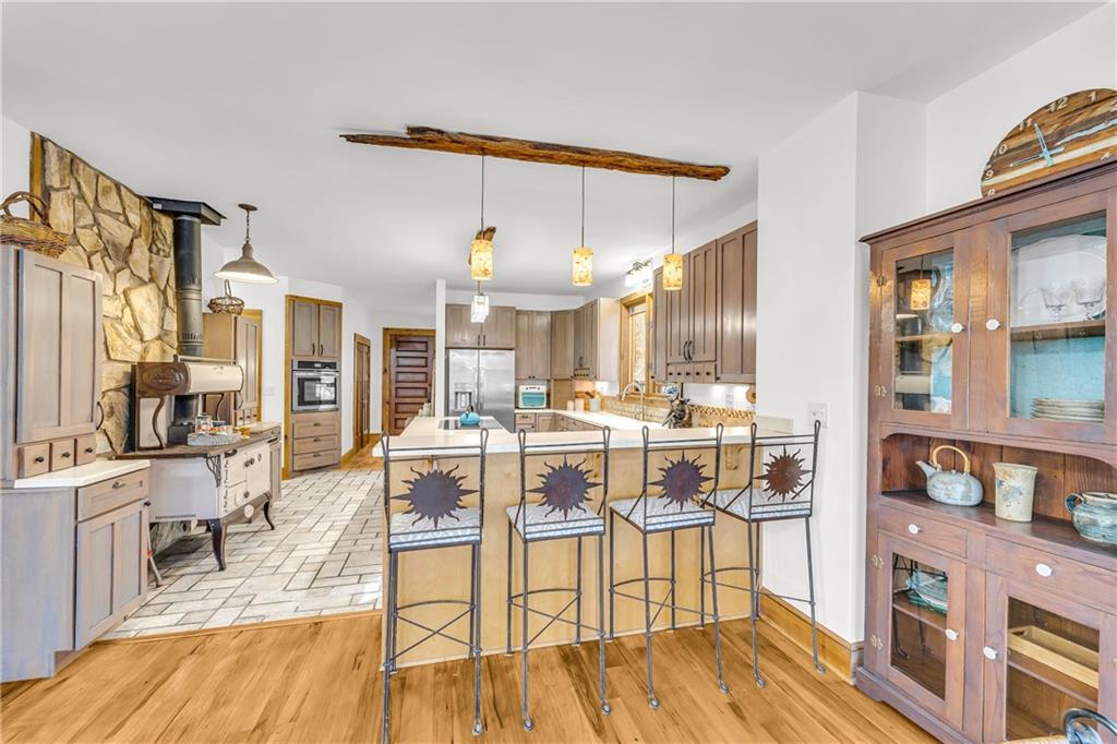 740 Little Rock Creek Road Cherry Log, GA 30522 - Photo 22 of 98 a living room with stainless steel appliances kitchen island granite countertop furniture and a wooden floor
