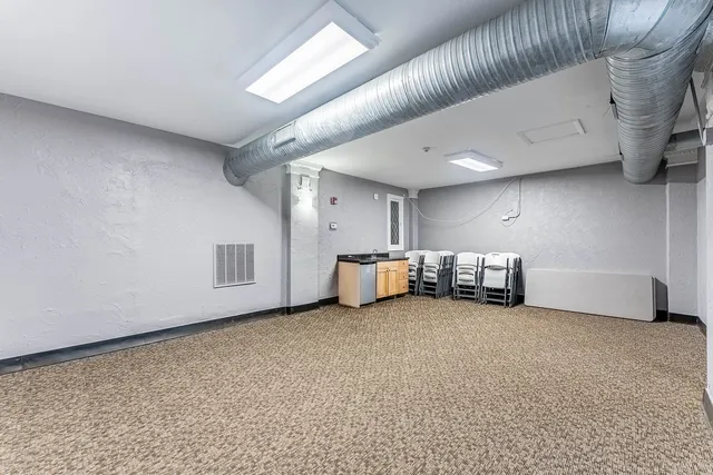 a view of an empty room with a fireplace