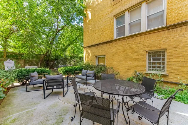 a view of patio with large trees