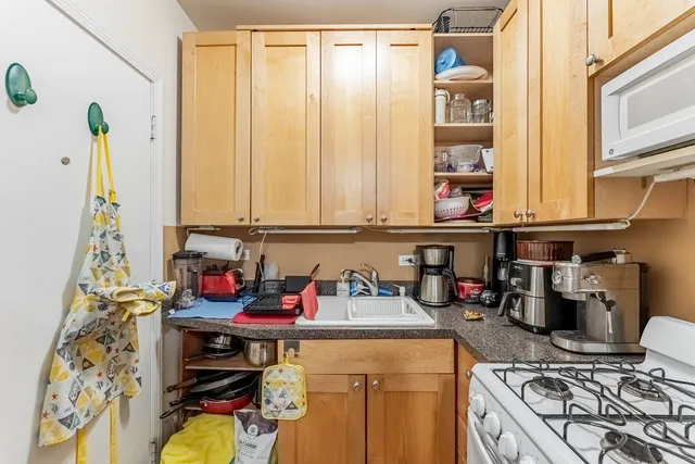 a kitchen with a stove and a white refrigerator