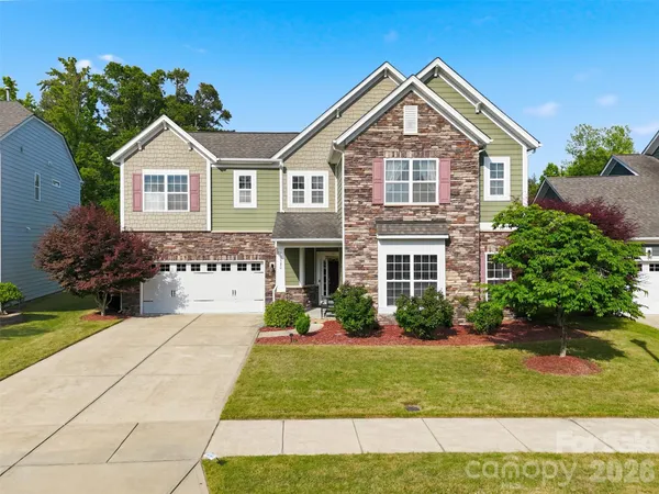 a front view of a house with a yard and garage