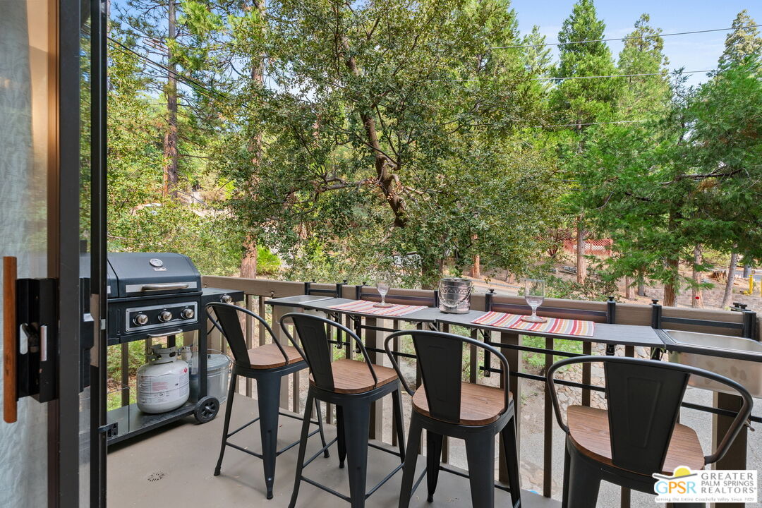 53615 Silver Fir Drive Idyllwild, CA 92549 - Photo 19 of 49 a patio with wooden floor and outdoor seating