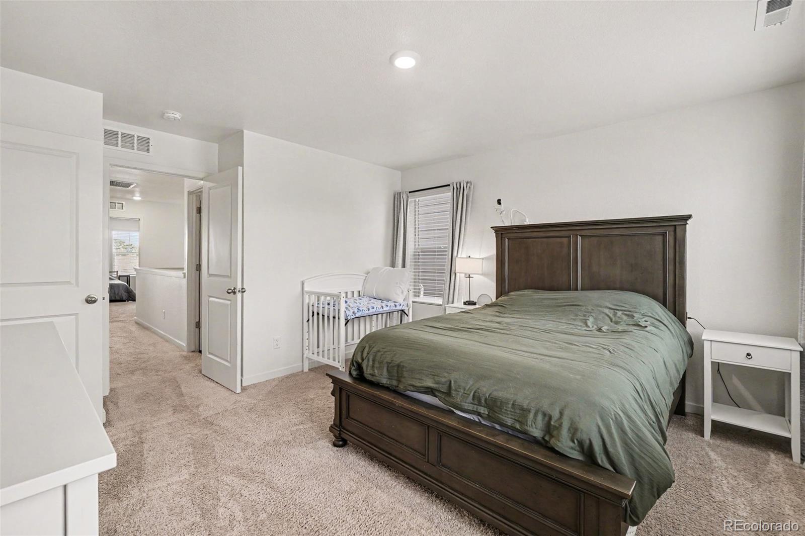 7008 Kali Court Frederick, CO 80530 - Photo 11 of 28 a bedroom with a bed and a cabinets