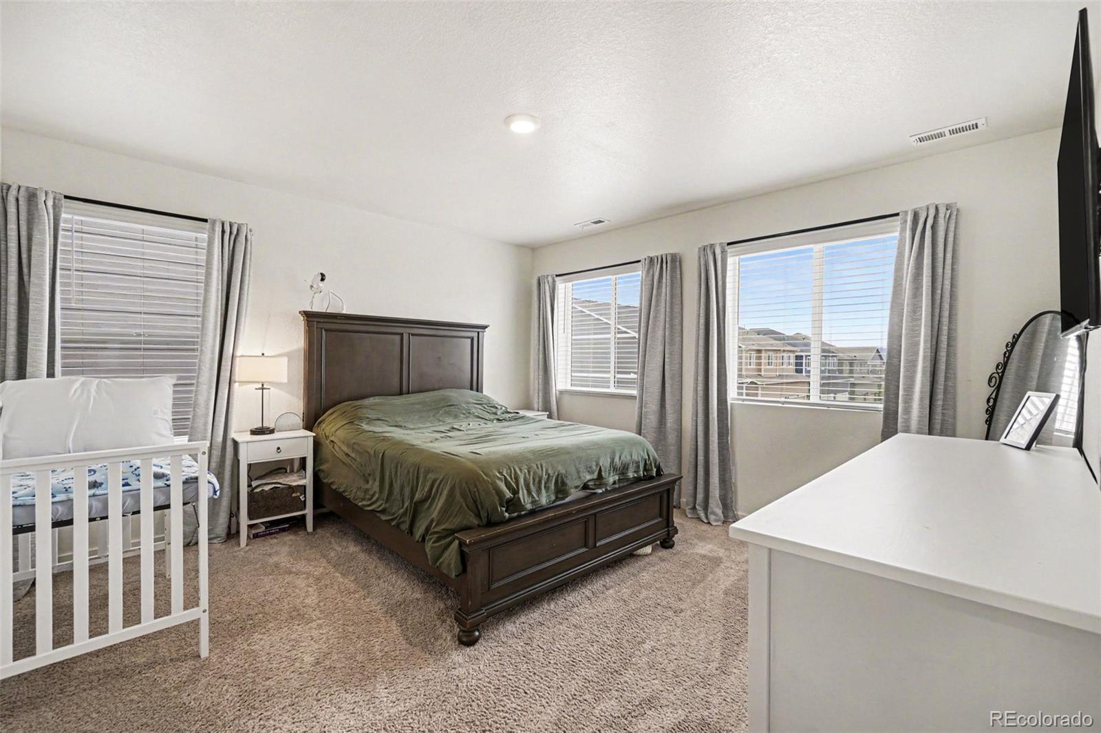7008 Kali Court Frederick, CO 80530 - Photo 12 of 28 a bed sitting in a bedroom next to a window