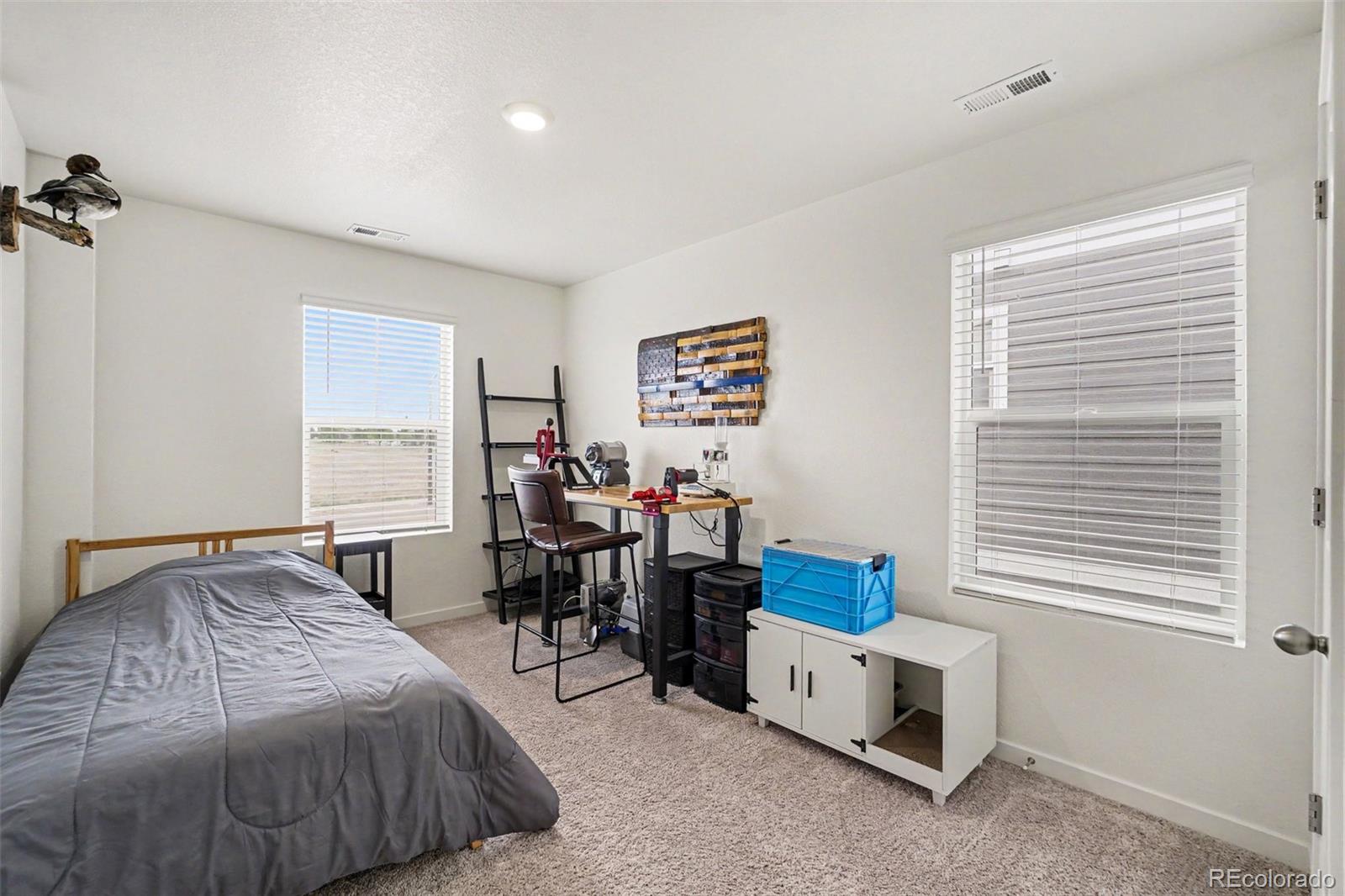 7008 Kali Court Frederick, CO 80530 - Photo 14 of 28 a bedroom with furniture and a window