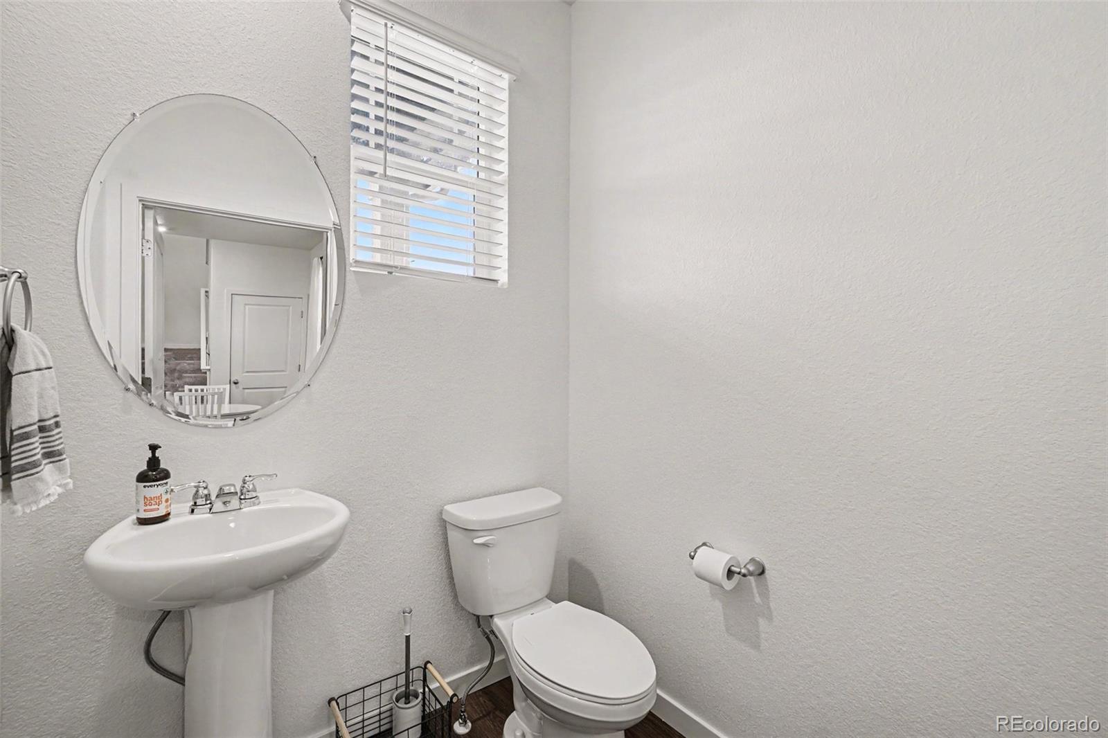 7008 Kali Court Frederick, CO 80530 - Photo 18 of 28 a bathroom with a sink a toilet and mirror