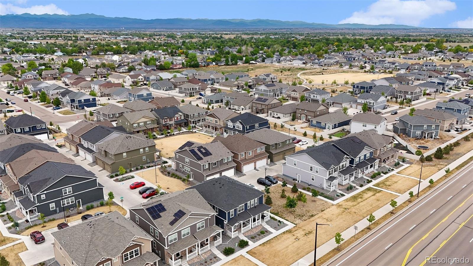 7008 Kali Court Frederick, CO 80530 - Photo 23 of 28 an aerial view of a city with lots of residential buildings and mountain view in back