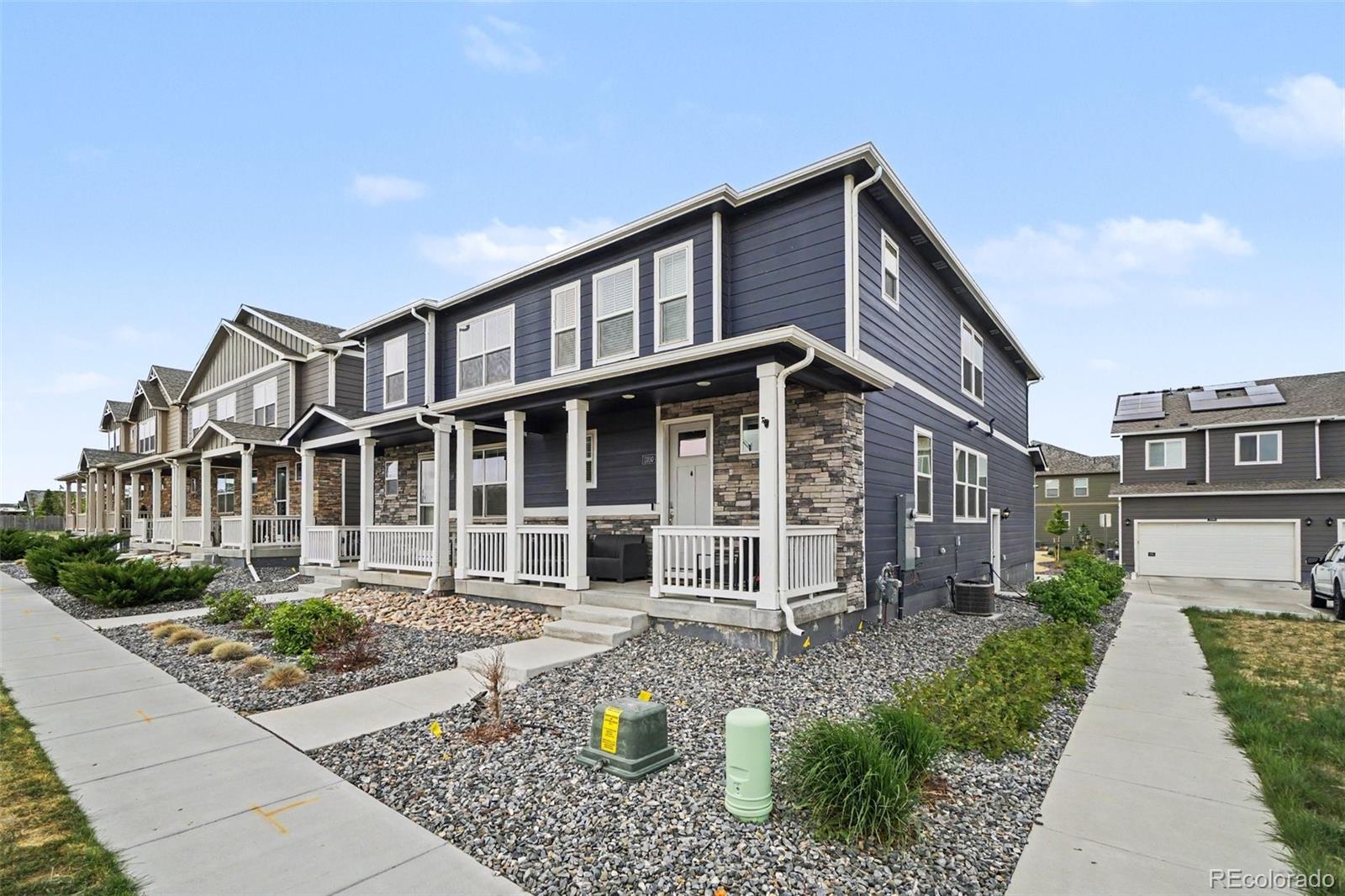 7008 Kali Court Frederick, CO 80530 - Photo 3 of 28 a front view of a house with garden