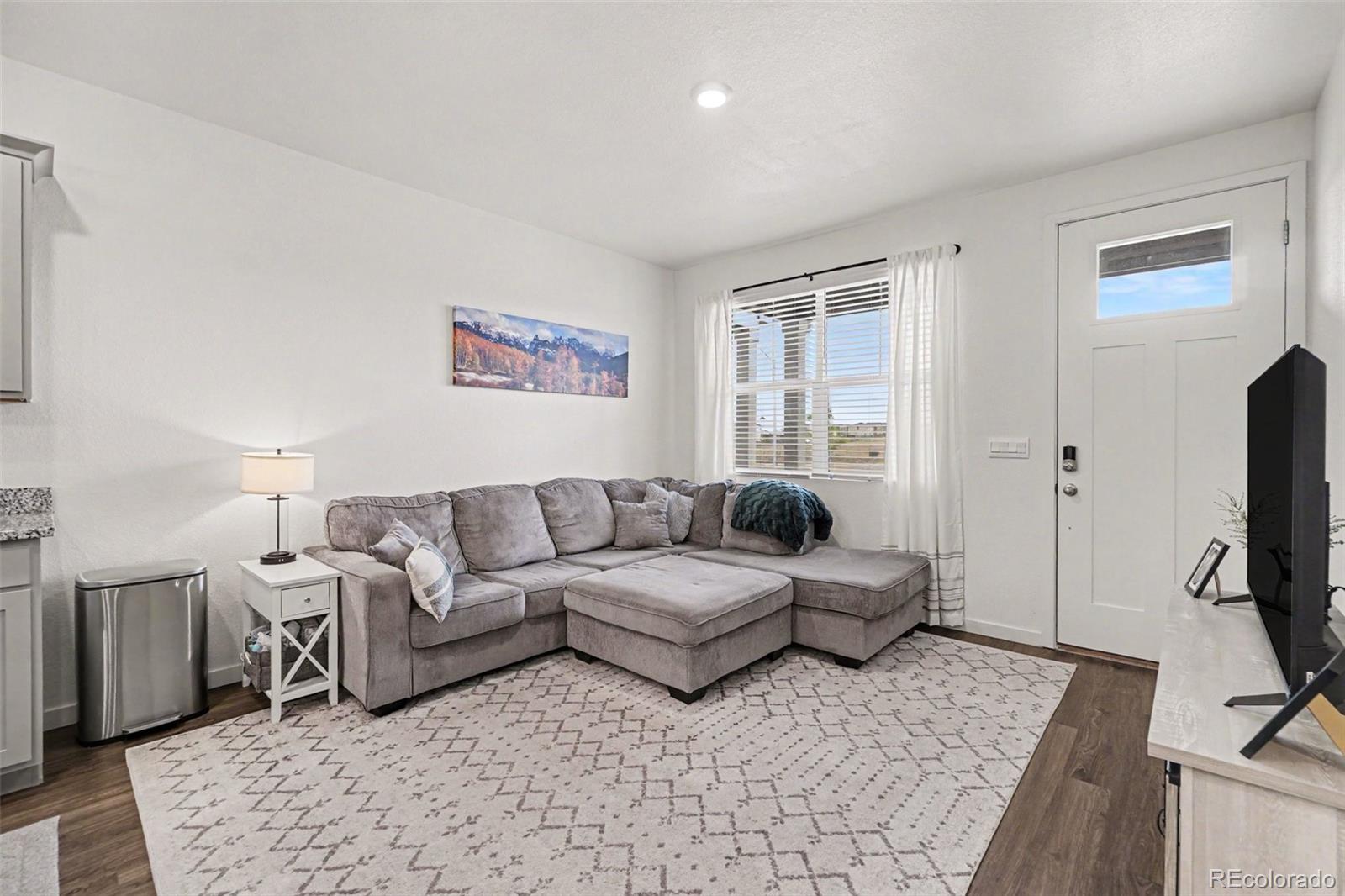 7008 Kali Court Frederick, CO 80530 - Photo 5 of 28 a living room with furniture flat screen tv and a window