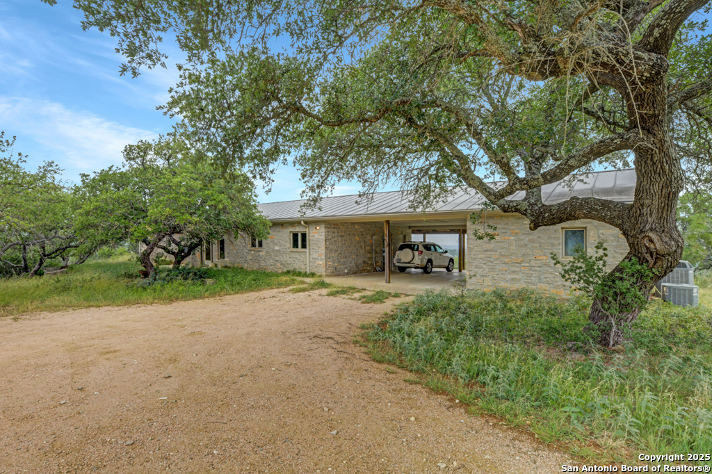 306 Fieldstone Johnson City, TX 78636 - Photo 2 of 31 a view of a house with a tree next to a yard