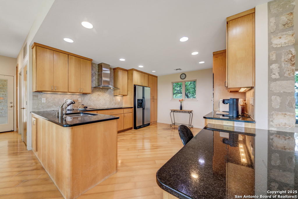 306 Fieldstone Johnson City, TX 78636 - Photo 7 of 31 a kitchen with stainless steel appliances a stove a sink and a refrigerator