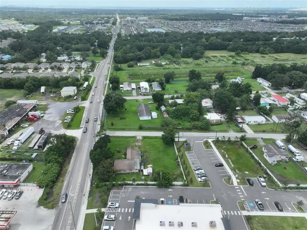 an aerial view of residential houses with outdoor space and river