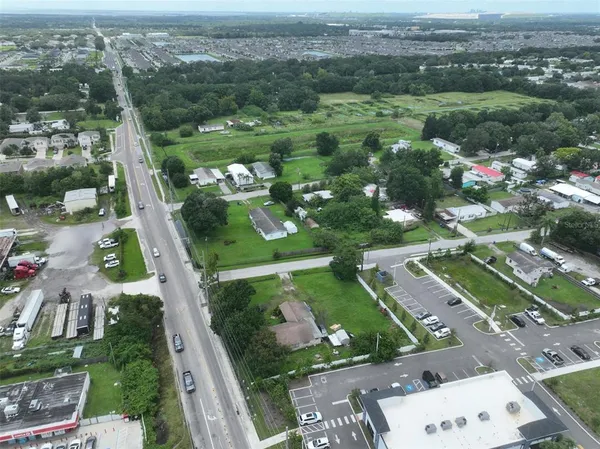 an aerial view of city lake and trees
