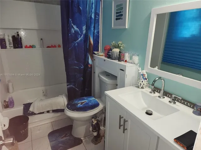 a bathroom with a sink toilet and a mirror