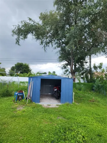 a view of a backyard with furniture and a garden