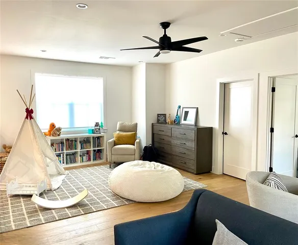 a living room with furniture and a large mirror