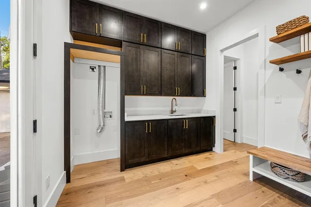 a bathroom with a double vanity sink a large mirror and shower