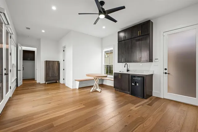 a living room with stainless steel appliances kitchen island granite countertop furniture and a refrigerator