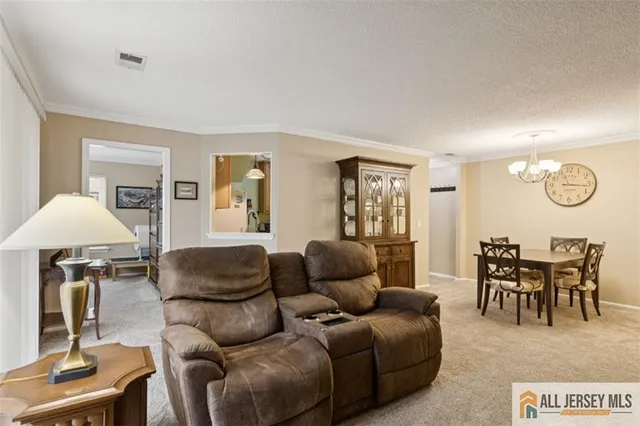 a living room with furniture a window and a lamp