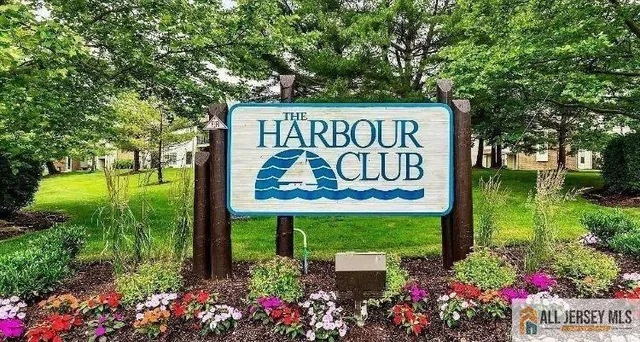 a view of a tennis ground with large trees