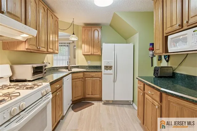 a kitchen with stainless steel appliances a sink a stove and a refrigerator