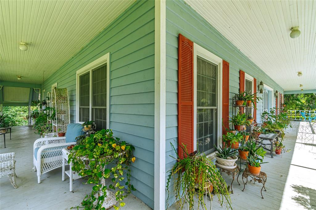 15795 Northwest 86th Avenue Reddick, FL 32686 - Photo 19 of 83 a house with potted plants in front of door