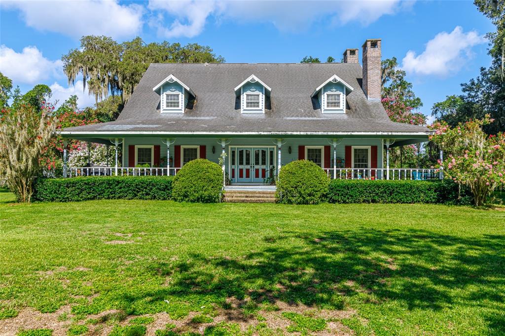 15795 Northwest 86th Avenue Reddick, FL 32686 - Photo 2 of 83 a view of a house with a garden