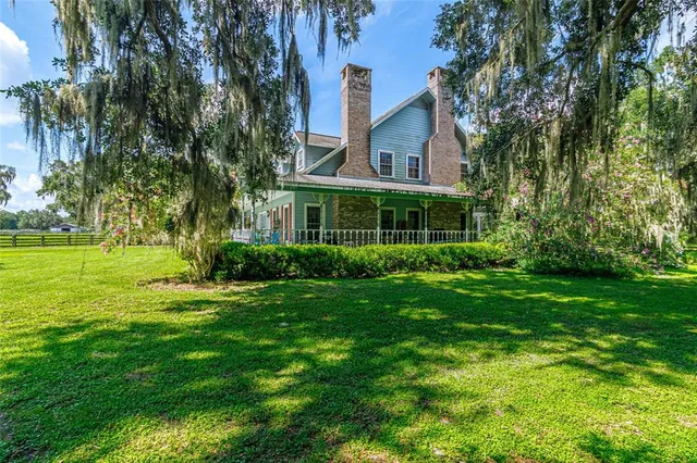 a view of a dining room with furniture a chandelier and wooden floor