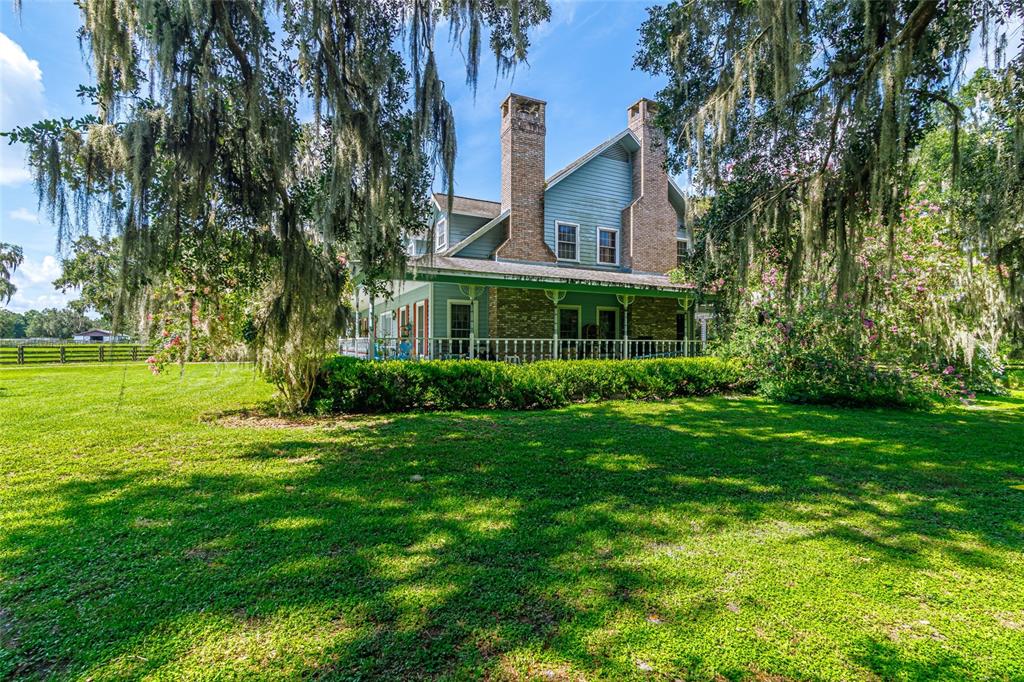 15795 Northwest 86th Avenue Reddick, FL 32686 - Photo 22 of 83 a view of a house next to a big yard and large trees