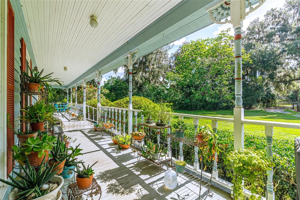 15795 Northwest 86th Avenue Reddick, FL 32686 - Photo 25 of 83 a view of a balcony with floor to ceiling windows and wooden fence