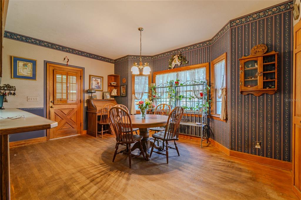 15795 Northwest 86th Avenue Reddick, FL 32686 - Photo 32 of 83 a view of a dining room with furniture window and wooden floor