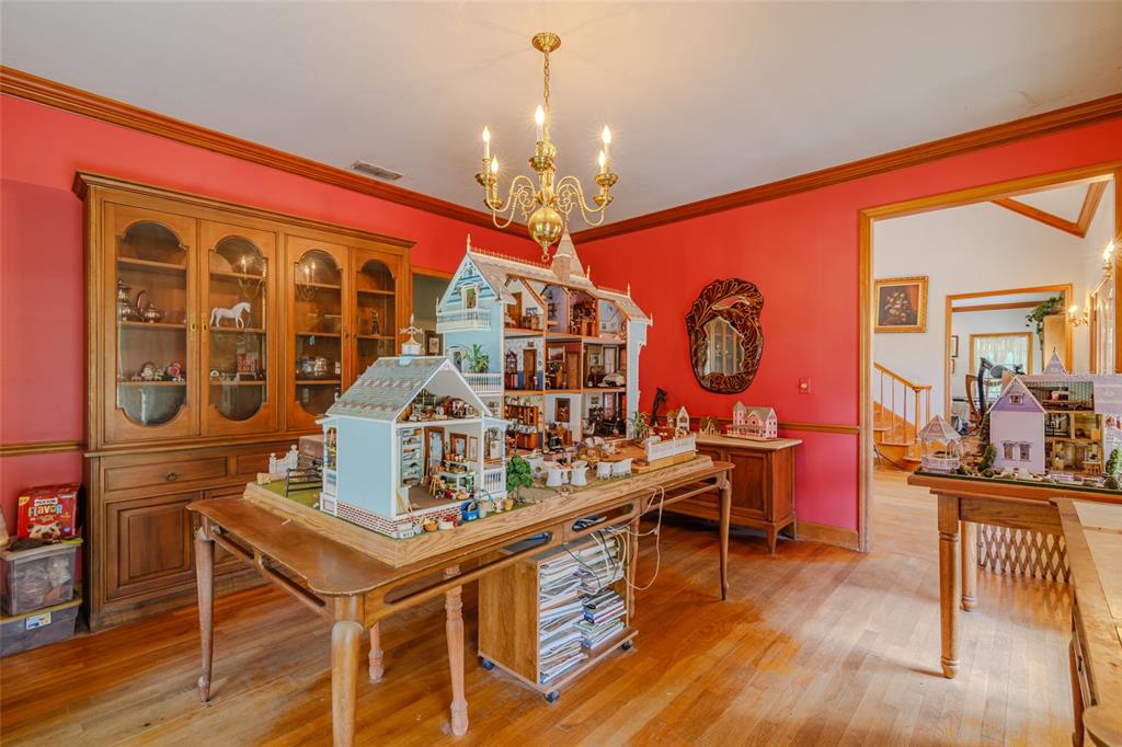 15795 Northwest 86th Avenue Reddick, FL 32686 - Photo 33 of 83 a view of a dining room with furniture a chandelier and wooden floor