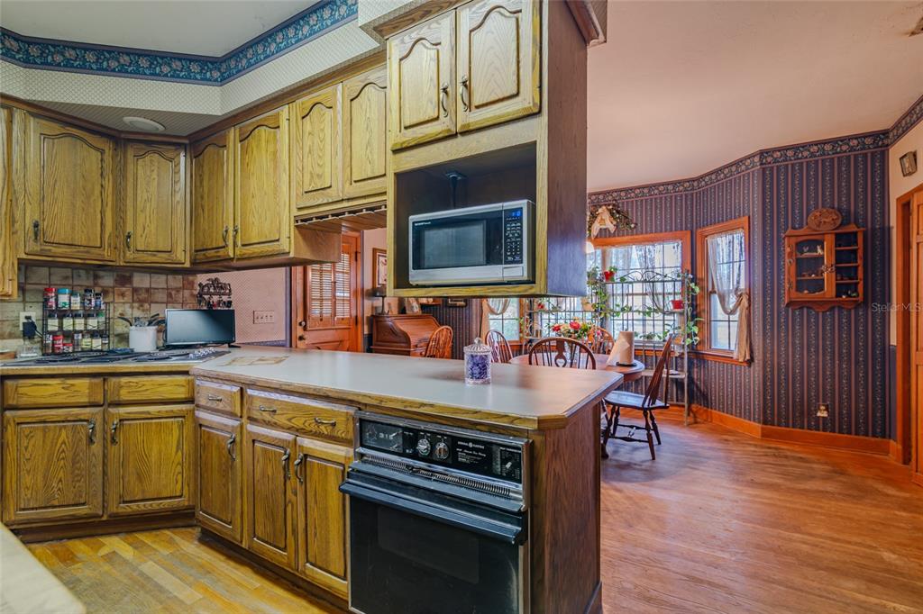 15795 Northwest 86th Avenue Reddick, FL 32686 - Photo 37 of 83 a kitchen with stainless steel appliances granite countertop a stove and cabinets