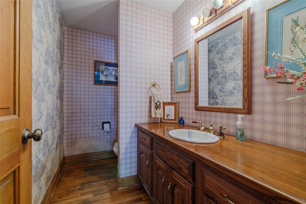 15795 Northwest 86th Avenue Reddick, FL 32686 - Photo 50 of 83 a bathroom with a granite countertop sink a mirror and a shower