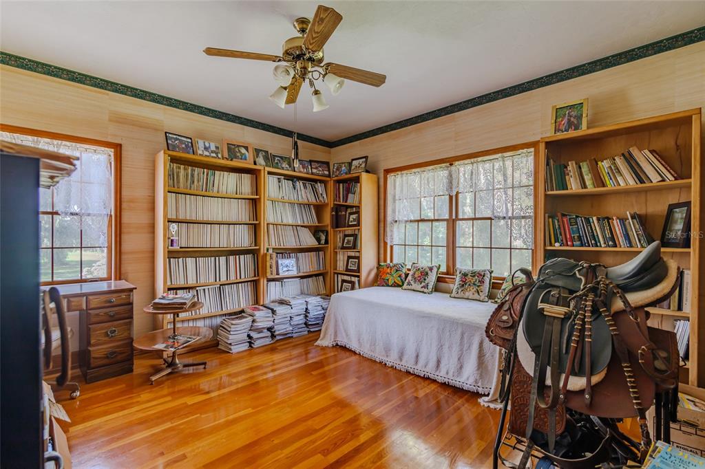 15795 Northwest 86th Avenue Reddick, FL 32686 - Photo 60 of 83 a bedroom with furniture and a book shelf