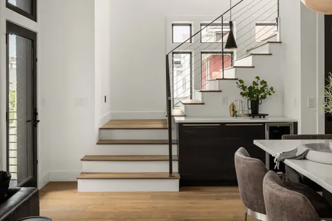 a view of entryway and hall with wooden floor
