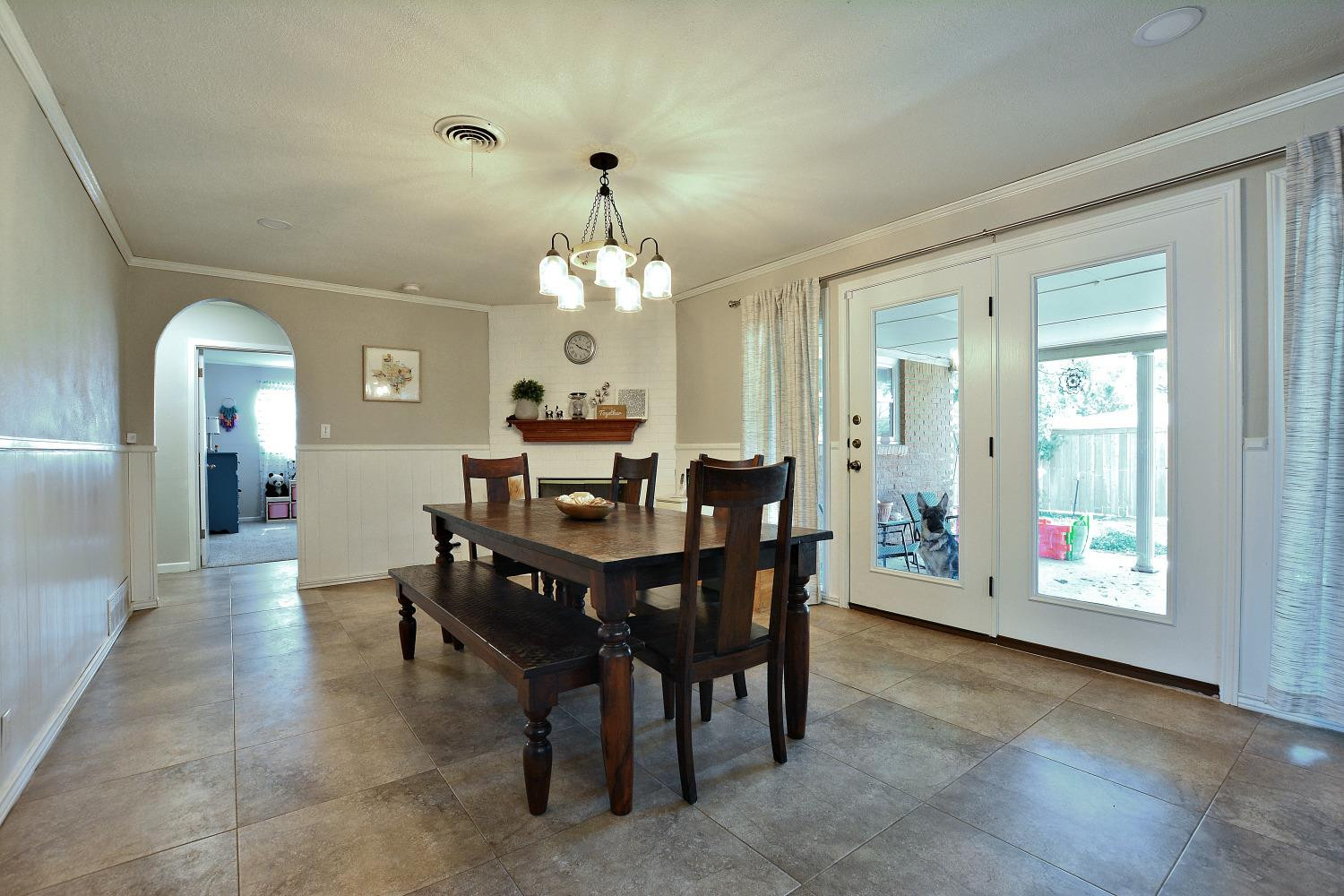 4903 17th Street Lubbock, TX 79416 - Photo 8 of 25 a view of a dining room with furniture and chandelier