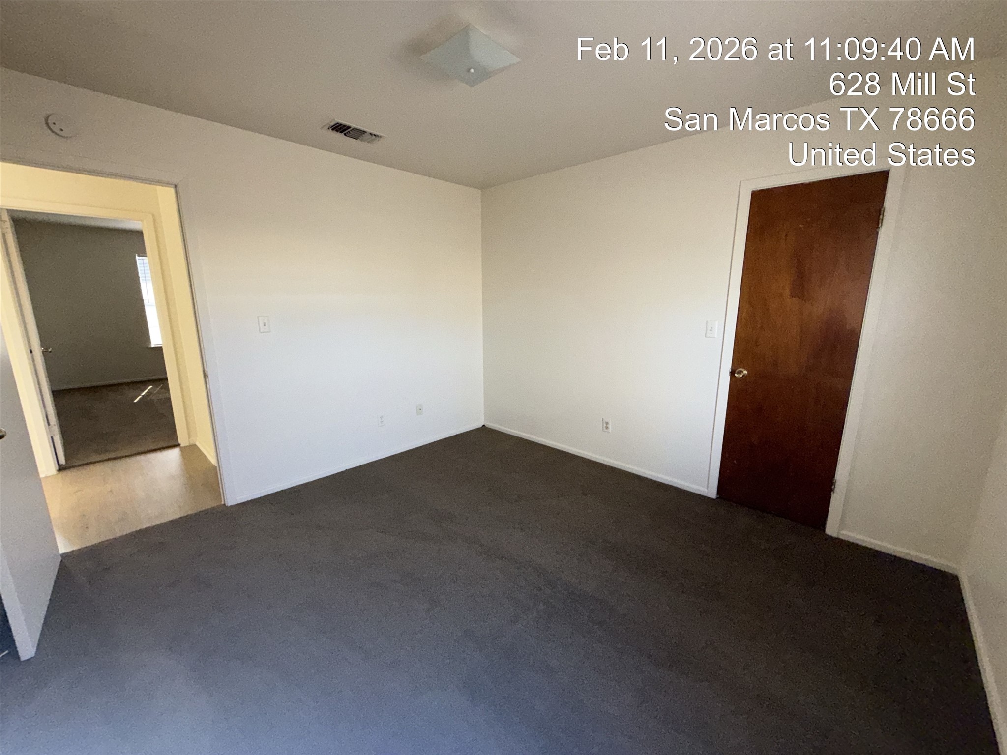 628 Mill Street, Unit B San Marcos, TX 78666 - Photo 11 of 13 Unfurnished bedroom with dark colored carpet