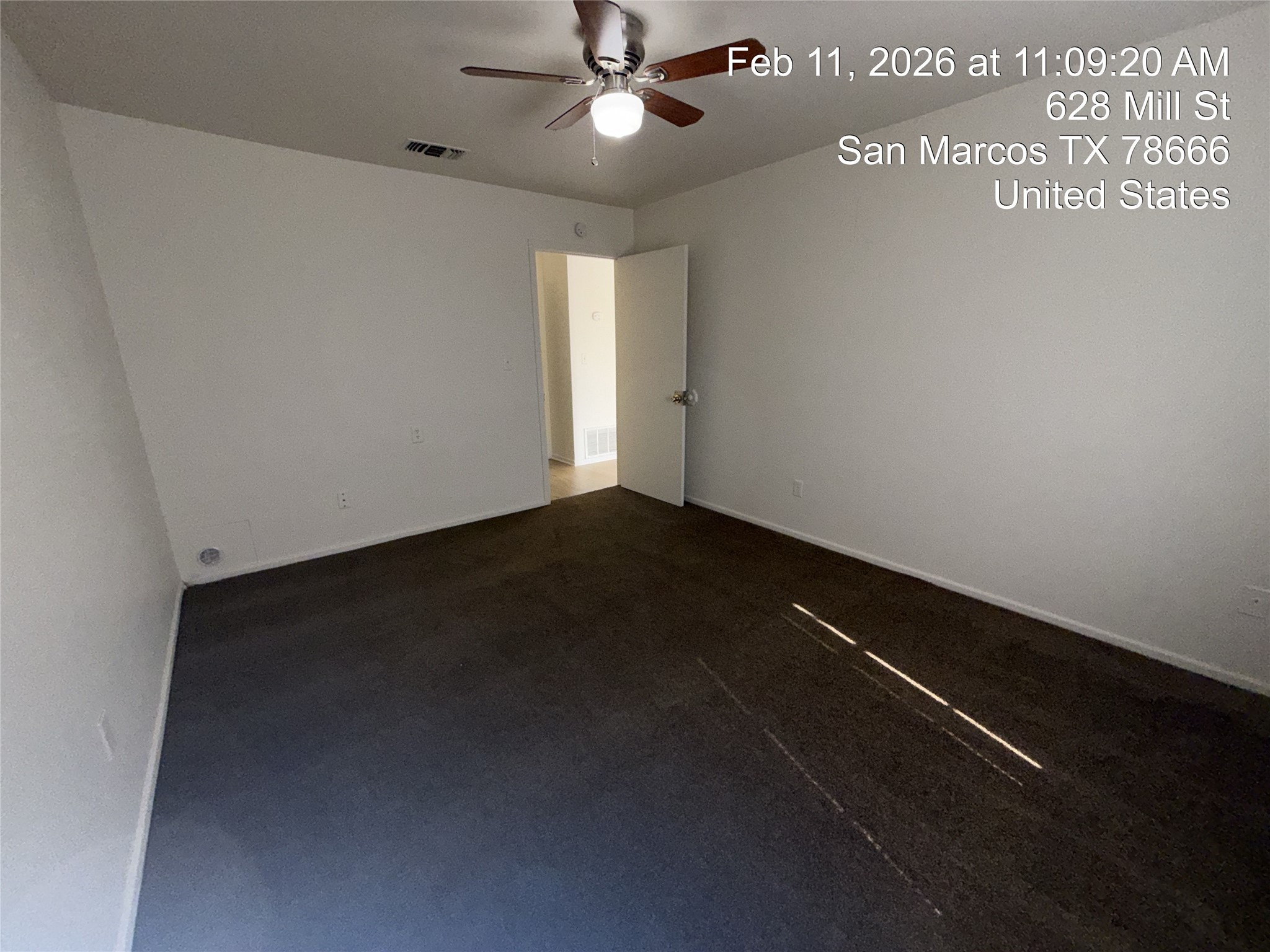 628 Mill Street, Unit B San Marcos, TX 78666 - Photo 12 of 13 Unfurnished room featuring dark colored carpet and a ceiling fan